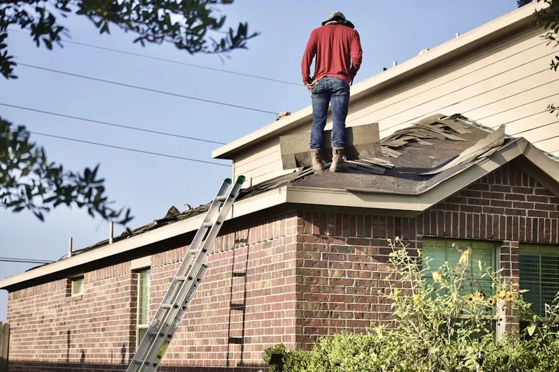 Professional roofer working on a residential roof in Tinicum